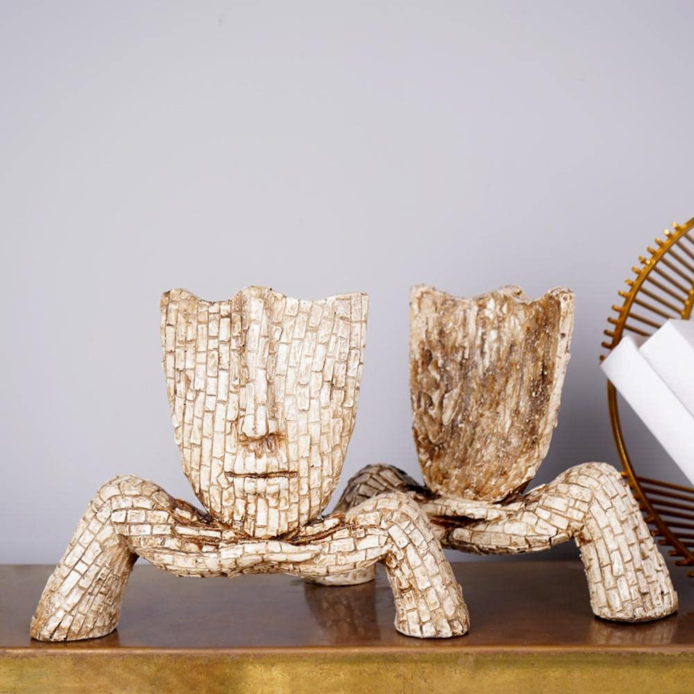Artistic face planter sculpture in unique design with textured finish for decorative use