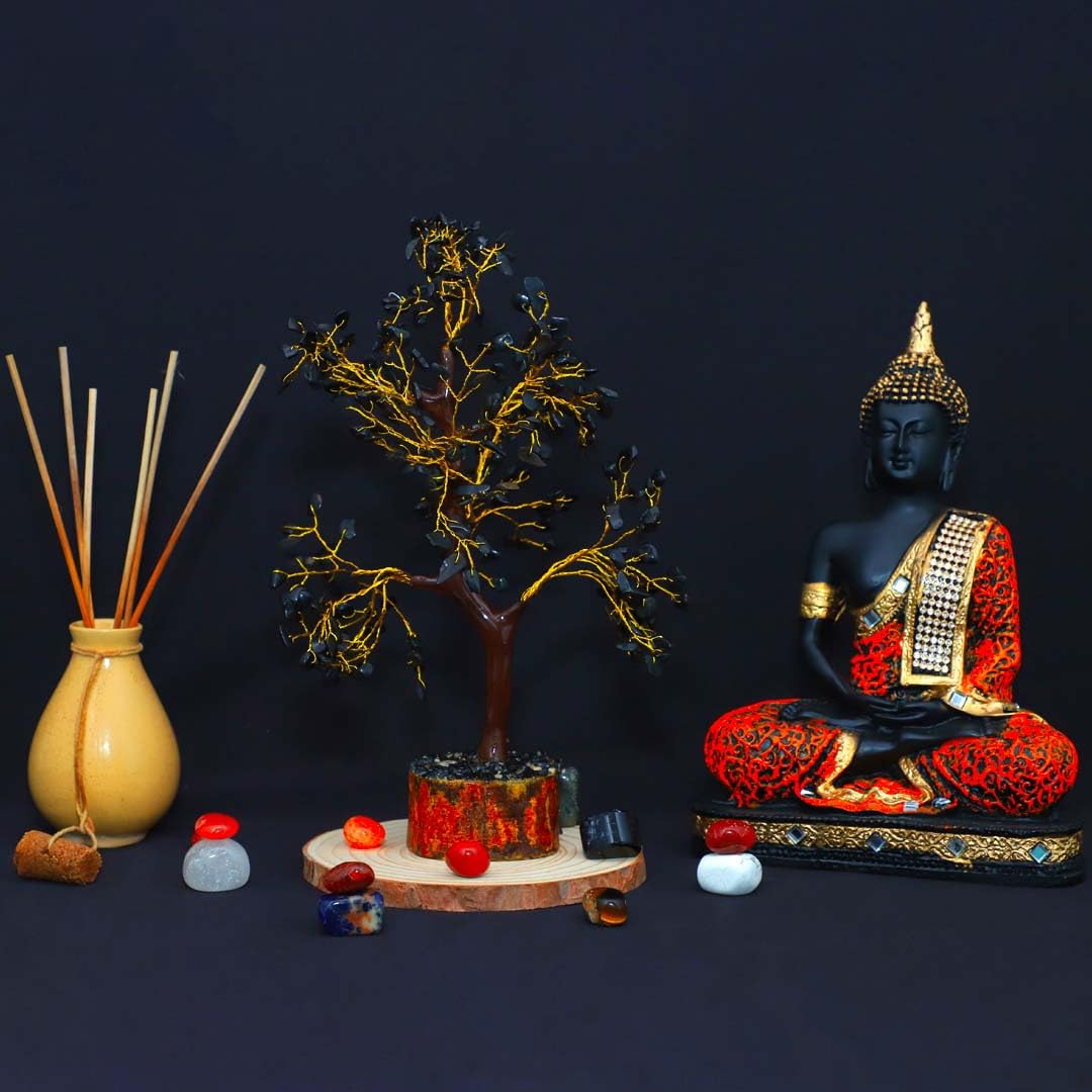 Black Crystal Tree decor with Buddha statue and decorative stones on a black background
