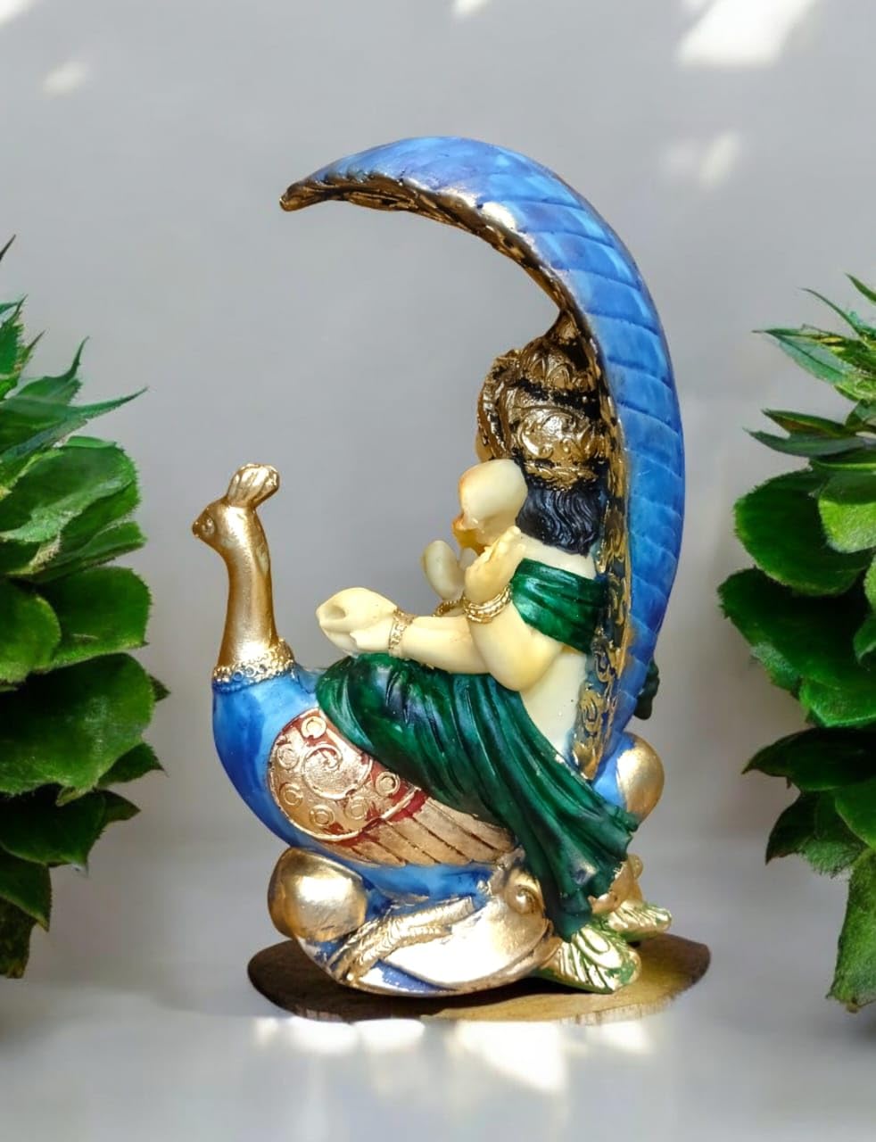 Decorative Ganesha idol with peacock in vibrant colors, ideal for home decor and spiritual ambiance