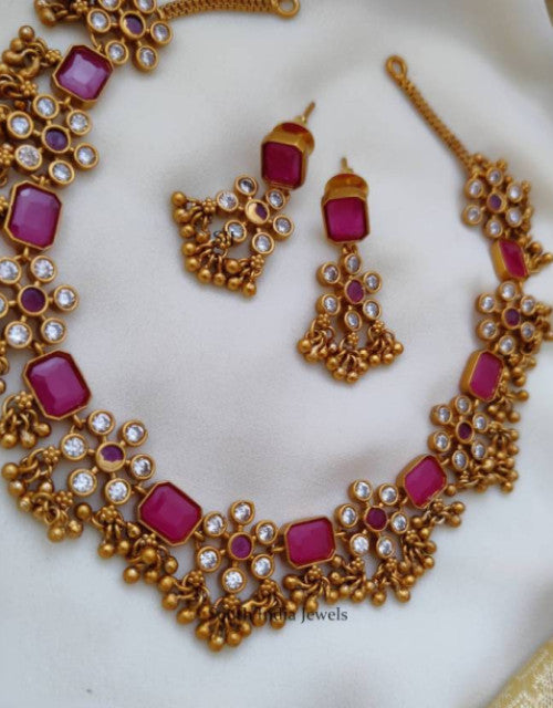 Elegant designer choker jewelry for weddings featuring vibrant red stones and intricate gold detailing.