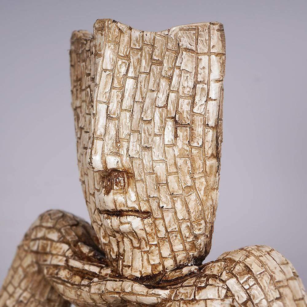 Artistic face planter sculpture with textured details in a neutral color, perfect for home decor