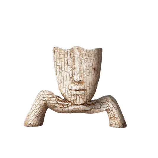 Artistic face planter sculpture made of textured ceramic with a unique expressive design