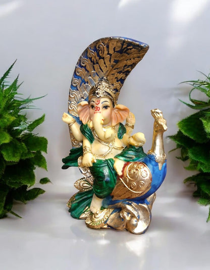 Decorative Ganesha idol with peacock, intricately designed with colorful accents and detailed features