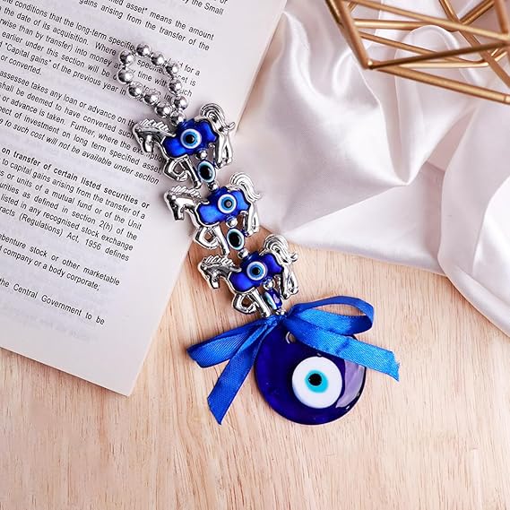 Evil Eye Home Decor Charm with Blue Ribbon and Silver Accents on Wooden Surface